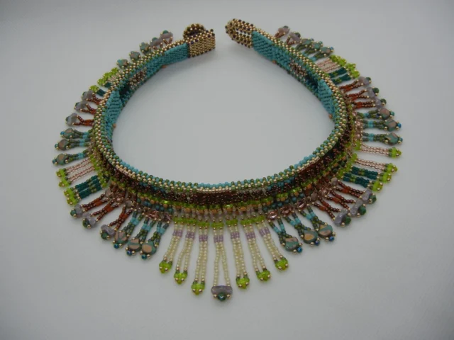 Keep taking the TOHO Challenge, 2025 'Sonoran Sunset'

This beautiful design was created by mini kit designer Tanja Paschke.

Dear Toho team,
I finished my work for the Toho Challenge 2025 and send you pictures.
You can see other bead work of me on my YouTube-channel:https://www.youtube.com/@TanjaPaschke

Here is my story:
I'm Tanja Paschke from Berlin, Germany. Since childhood, I've loved crafting and sewing, and I helped my grandpa in the workshop. He worked a lot with wood. My grandmother had countless craft books. I've had a bead loom for ages. At some point, I came across a book about beaded jewelry. That's how I started beading over 10 years ago. I really enjoyed designing things, and I still do.
But I had no idea I'd one day participate in an event like the Toho Challenge.
I wasn't familiar with the Sonoran Desert. I looked at some photos of the desert, especially for the colors. Since I draft patterns, I threaded something like a collar based on them.
Sincerely yours
Tanja Paschke

There are many more to see at https://www.facebook.com/TeamTOHO/

#tohobeads #tohochallenge2025 #teamtohobeads #starmanbeads #bobbybeadstore #twinklebeadsdortmund #ilovetohobeads #tohobeadsconnectingpeople #glassbeadart #tohochallenge
#トーホービーズ #トーホーチャレンジ